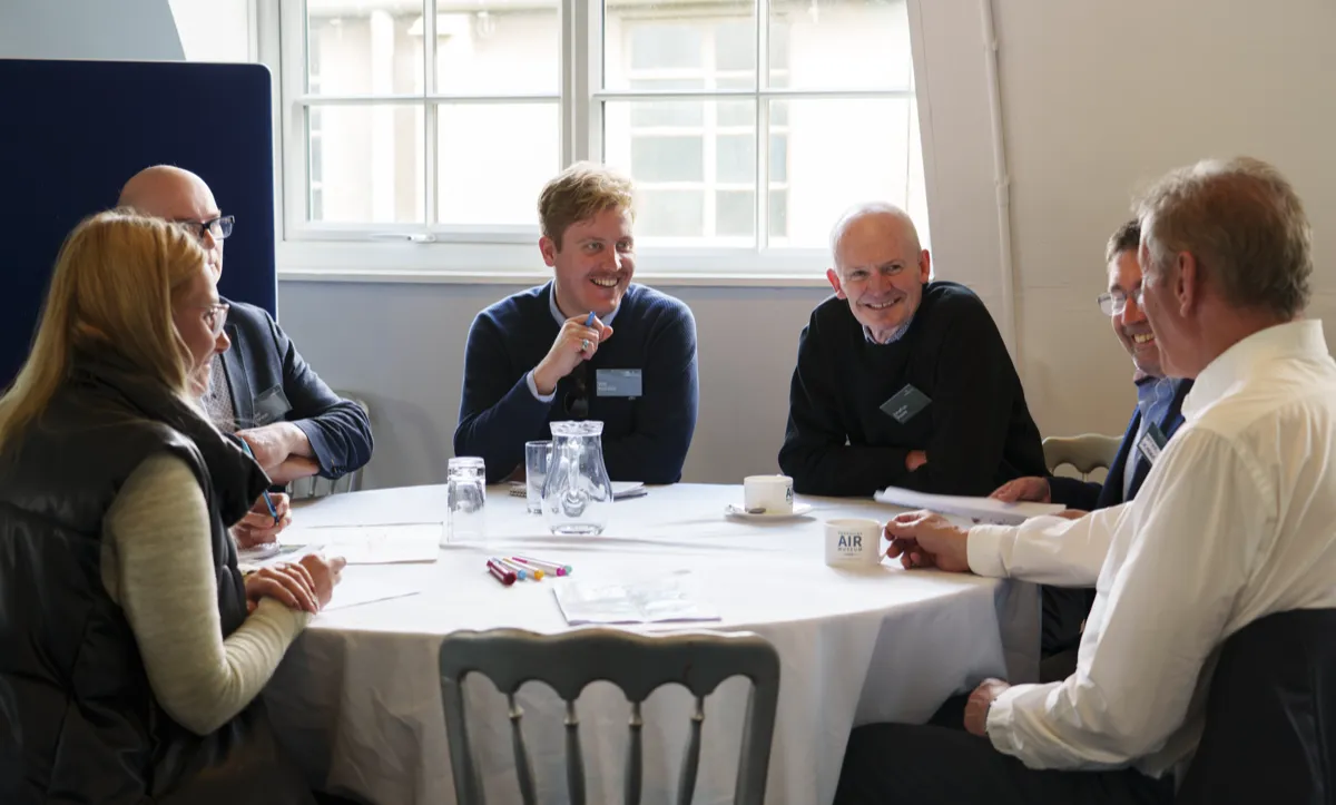 People around a table with pens and paper at a Langwith Village planning workshop